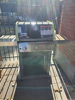 Front view of Weber Spirit 3-burner propane grill with side shelves