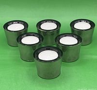 Six silver plated tealight candle holders displayed together