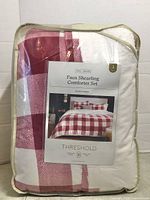 Front of packaged Threshold faux shearling comforter set