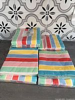 All ten sealed packs of multicolour striped Spritz napkins displayed