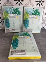 Three Spritz balloon arch kits on counter
