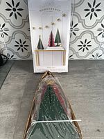 Box and packaged wooden tree set showing brand and product