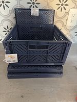 One crate assembled, three collapsed beneath, tags attached