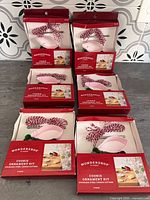 Six boxed cookie ornament kits arranged on countertop