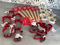 Collection of spatulas and multiple stacks of cookie cutters on tabletop