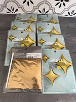 Eight sealed Spritz balloon kits laid out face-up showing packaging front