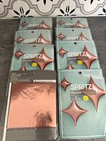 Eight retail packs of Spritz pink foil balloons