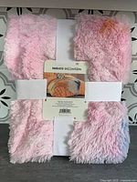Front view of folded pastel faux fur blanket with Makers Collective label