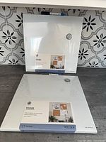Two packaged 14x14 U Brands magnetic dry erase boards shown together