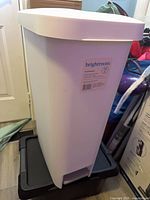 Front angled view of Brightroom 41.5 L white trash bin showing label and foot pedal