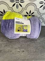 Rolled throw blanket with label visible