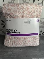 Front of packaged Room Essentials sheet set showing label