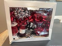 Front view of boxed Wondershop ribbon & bow set showing contents