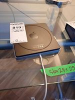 Top view of Apple USB SuperDrive showing attached USB cable and overall condition