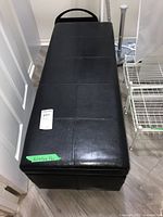 Full top view of black faux leather storage bench