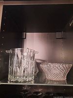 Ice bucket and pressed-glass shallow bowl on shelf