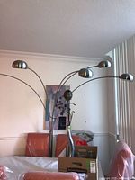 Full view of five-arm arc floor lamp with dome shades