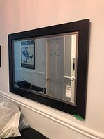 Full view of framed mirror on wall