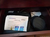 PEMF pad, manual sheet, cables inside drawer