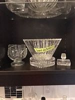Shelf view with Orrefors bowl, pedestal bowl, glass stopper