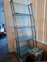 Full front view of metal and glass shelving unit
