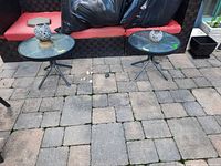 Both round side tables on patio showing size and style