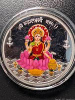 Front view of color printed Laxmi silver coin in capsule