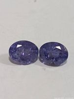 Close-up of two oval tanzanite gemstones