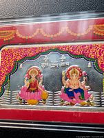 Front of silver bar with color images of Lakshmi and Ganesh