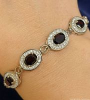 Bracelet worn on wrist showing front garnet links