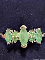 Front view showing five emerald stones