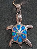 Front view of sterling silver turtle pendant with blue opalite inlay