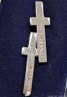 Front view of both sterling silver cross earrings showing Pianegonda engraving