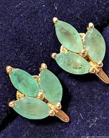 front view of both earrings showing emerald clusters