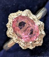 Front view of ring showing pink faceted stone and bezel detail