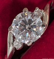 Close-up of ring showing center lab diamond and side accents