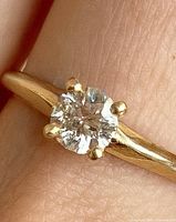 Close-up of diamond and prongs on gold band