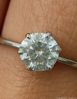 Close-up of moissanite in six-prong setting on white gold band