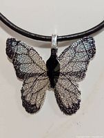 Front view of butterfly leaf pendant on cord