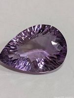 Front view of faceted pear-cut amethyst