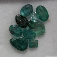 Close-up of loose emerald gemstones showing color and cuts