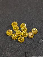 Group of yellow diamonds on dark surface