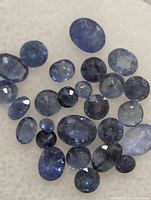 Group of loose blue sapphires on white background