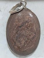 Front view of oval brown gemstone pendant set in silver