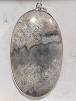 Front view of oval gemstone pendant in silver bezel