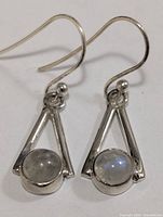 Front view of both silver moonstone earrings on hooks