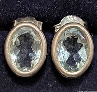Front view of both sterling silver earrings showing oval faceted aquamarine stones
