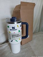 Front of 40oz Stanley Quencher H2.0 tumbler showing pattern, handle, lid and box
