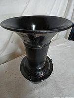 Full view of black metal horn front angle