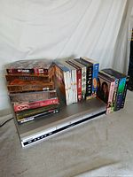 DVD player with stacked and lined DVDs